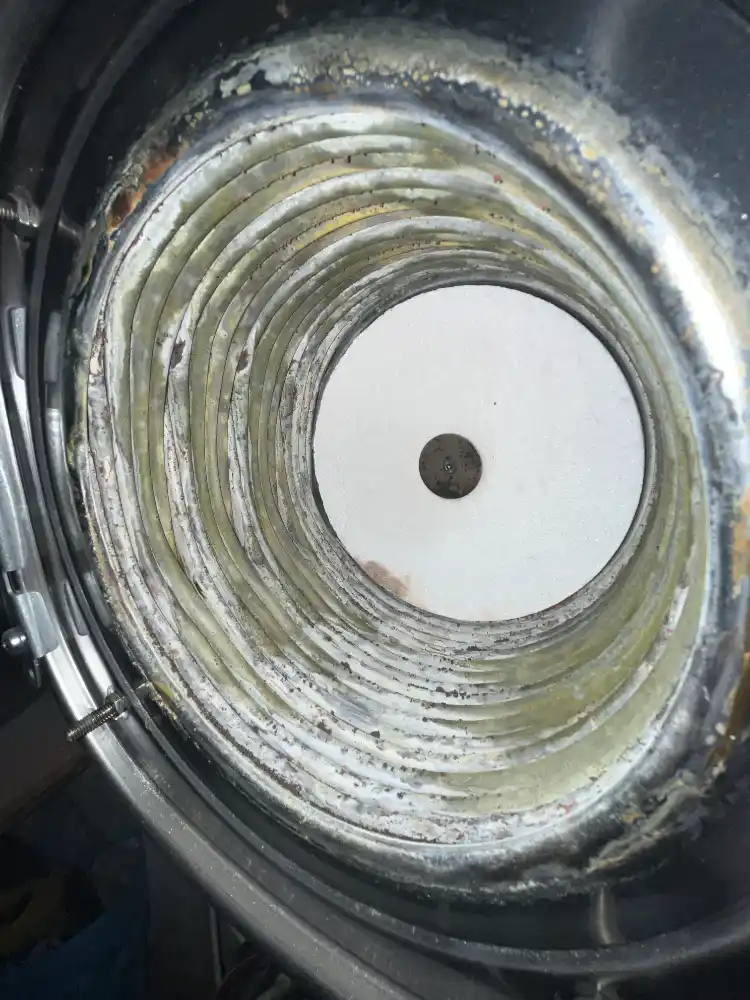 Close-up inspection of a boiler heat exchanger during servicing