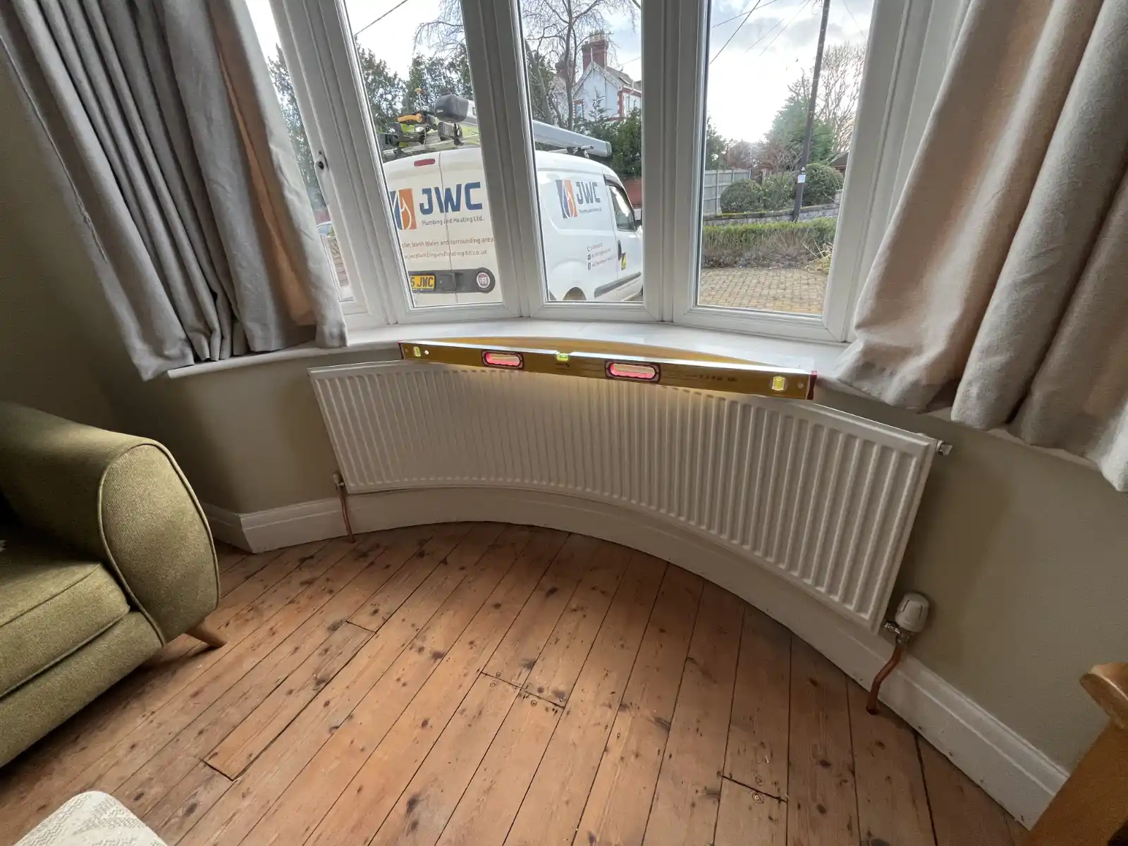 JWC Plumbing and Heating van outside a home during heating work