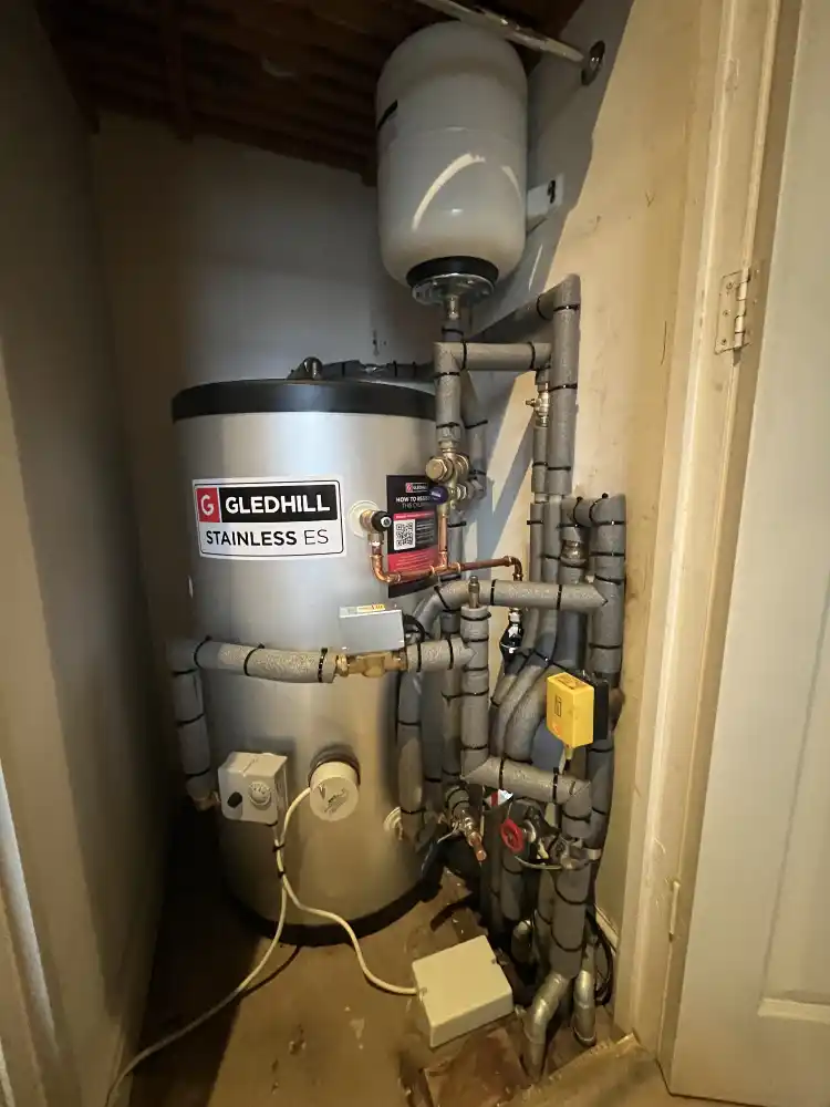 Unvented cylinder system and associated controls installed in a cupboard